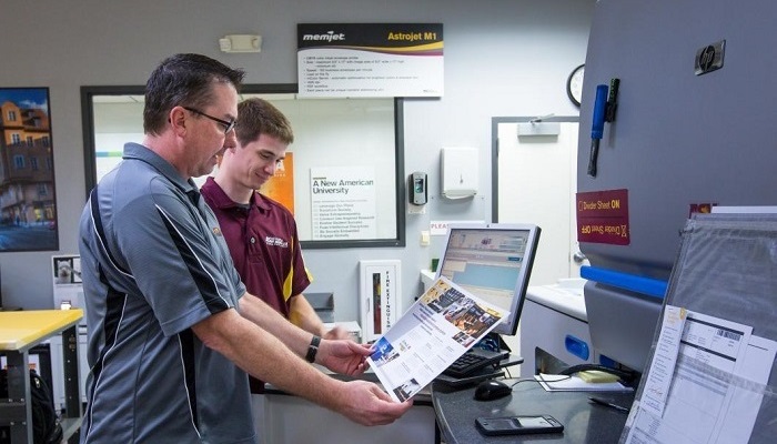 ASU printing staff inspecting a project