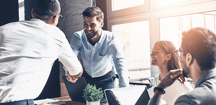 Colleagues shaking hands in meeting