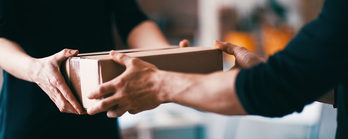 Person receiving a cardboard package