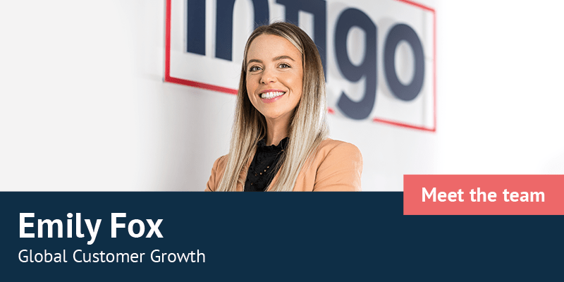 Emily Fox Standing in front of Infigo logo