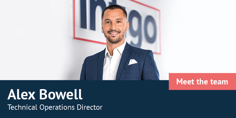 Alex Bowell standing in front of Infigo logo