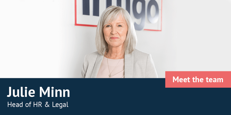 Julia Minn standing in front of Infigo logo