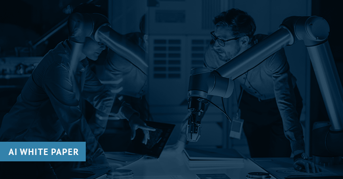 Two engineers working with a robot arm