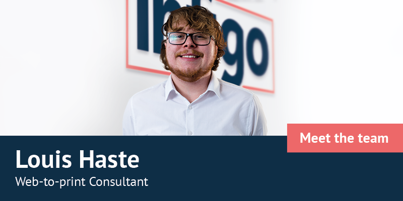 Louis Haste in front of Infigo logo