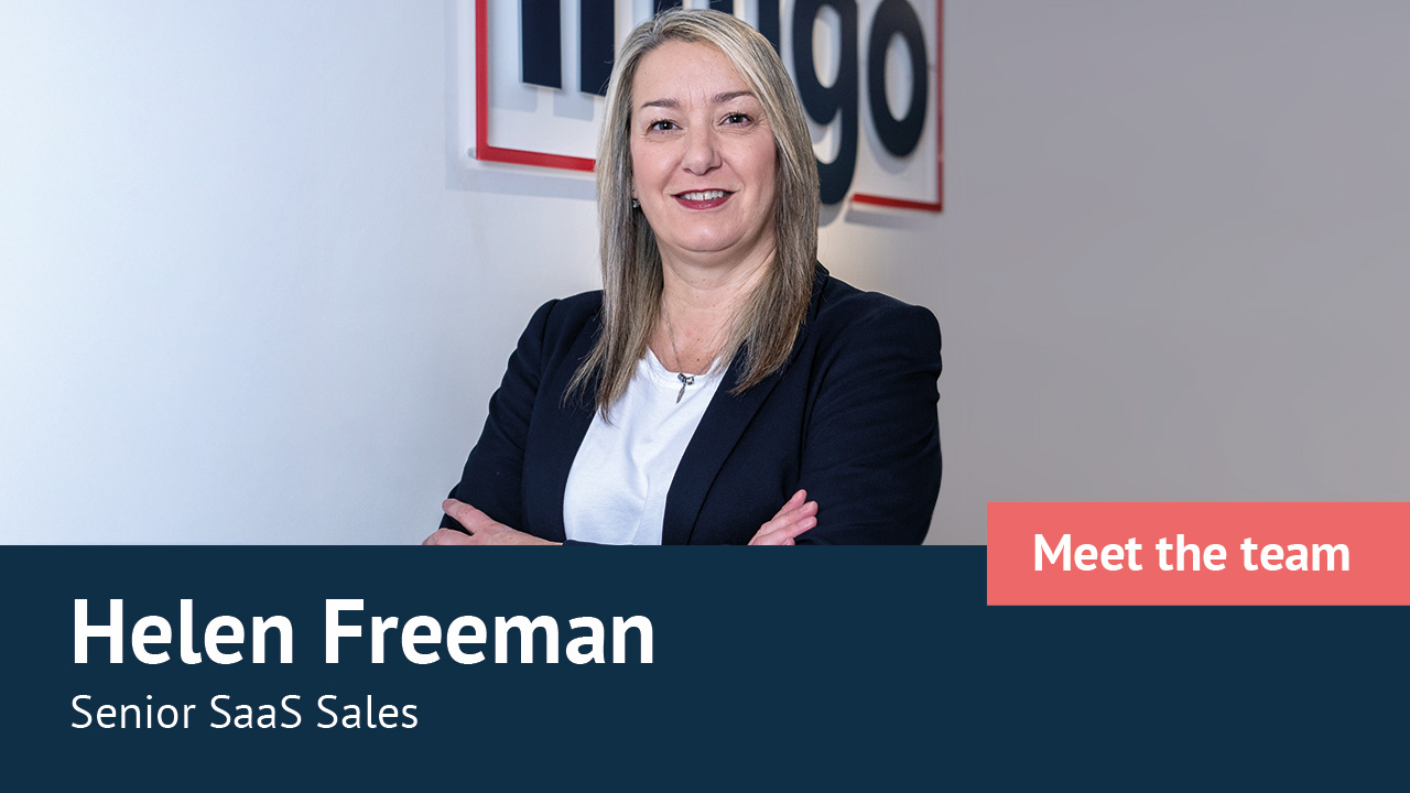 Helen Freeman in front of Infigo logo