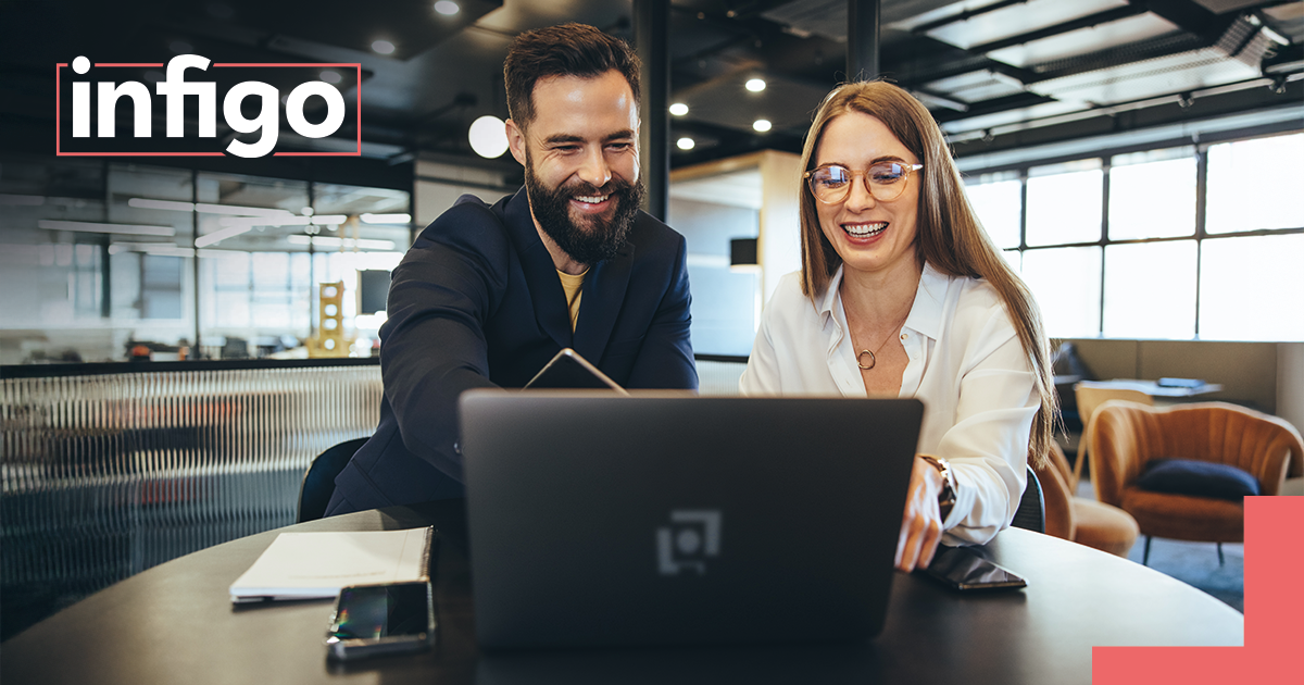 Two colleagues in an office working on a laptop