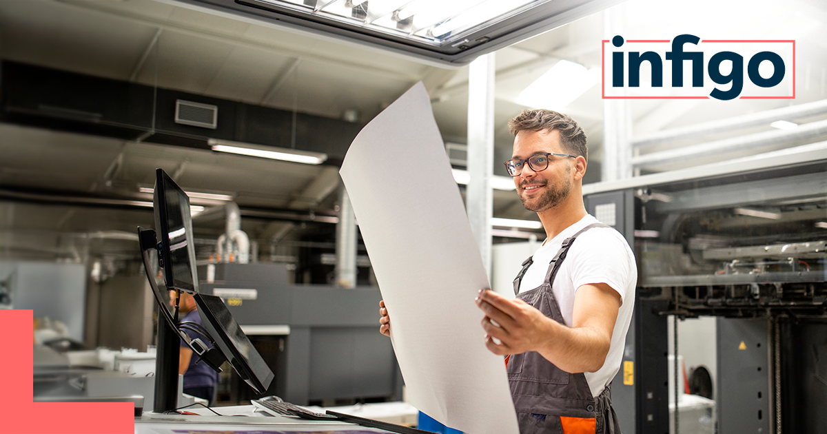 Man checking the quality of printed material